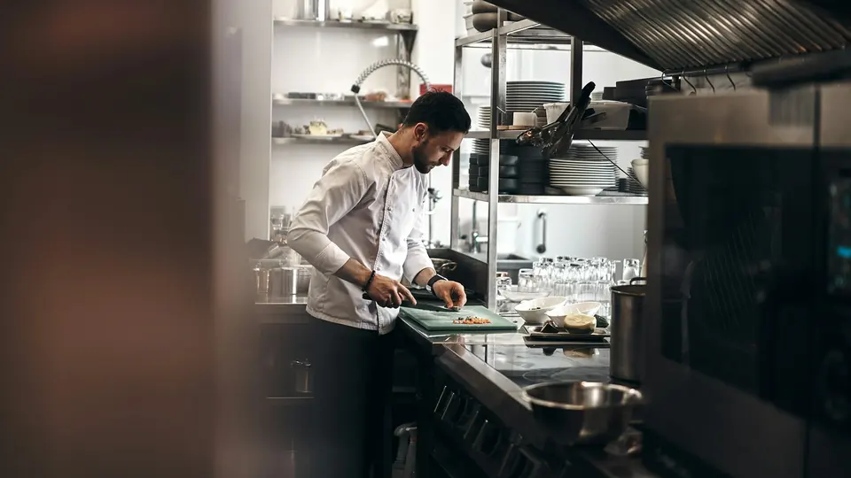 Chef preparing fresh dishes in a restaurant kitchen